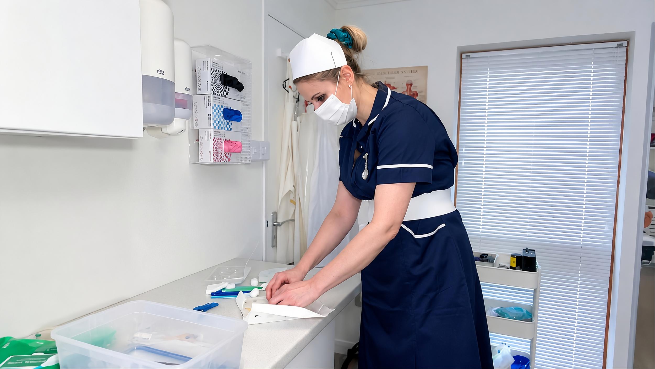 Miss Kimberley putting on medical gloves for a false dominance clinical BDSM session
